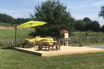 Deux femmes souriantes posent devant une voiture grise marquée ’France Bleu’, stationnée devant un bâtiment en pierre.