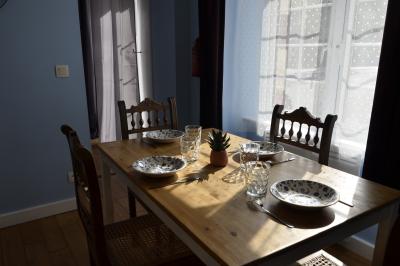 Deux femmes souriantes posent devant une voiture grise marquée ’France Bleu’, stationnée devant un bâtiment en pierre.