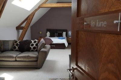 Deux femmes souriantes posent devant une voiture grise marquée ’France Bleu’, stationnée devant un bâtiment en pierre.