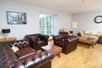 Deux femmes souriantes posent devant une voiture grise marquée ’France Bleu’, stationnée devant un bâtiment en pierre.