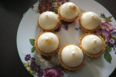 Bagels au sésame garnis de fromage frais, de légumes verts et d'herbes, disposés sur un plateau.