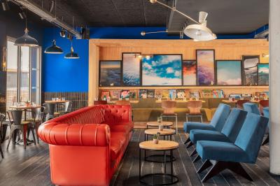 Chambre moderne avec lits superposés en bois, table ronde, chaise, et porte donnant sur l'extérieur.