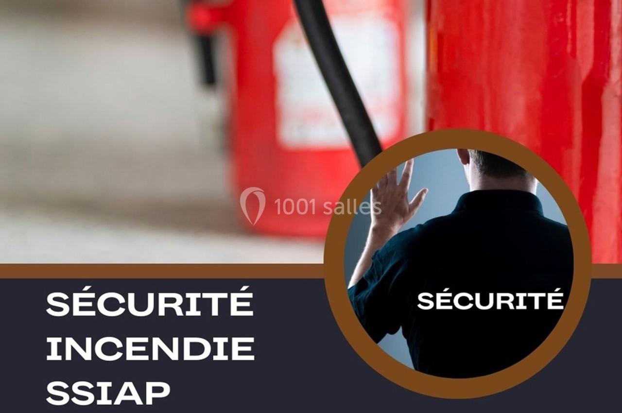 Extincteurs rouges en arrière-plan avec une personne de dos en uniforme noir, associée à la sécurité incendie.