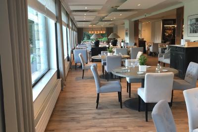 Buffet élégant en extérieur avec tables rondes garnies de verrines, fleurs et amuse-bouches sous des parasols.