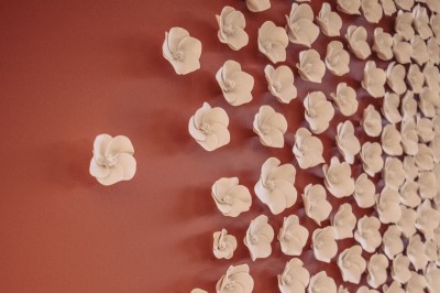 Bâtiment moderne avec façades vitrées et terrasses en bois, entouré de végétation au crépuscule.