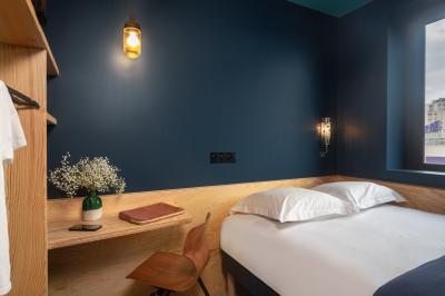 Façade d'un bâtiment moderne avec de grandes fenêtres, des arbres devant et une entrée vitrée portant le nom ’Eklo’.