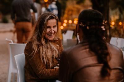 Miniature Location salle Valouse (Drôme) - Hameau de Valouse #16 Salle lumineuse avec tables et chaises en bois, grandes baies vitrées et plafond décoré de motifs végétaux.