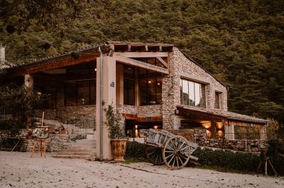Miniature Location salle Valouse (Drôme) - Hameau de Valouse #3 Salle lumineuse avec tables et chaises en bois, grandes baies vitrées et plafond décoré de motifs végétaux.