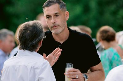 Miniature Location salle Valouse (Drôme) - Hameau de Valouse #44 Salle lumineuse avec tables et chaises en bois, grandes baies vitrées et plafond décoré de motifs végétaux.