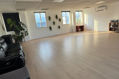 Toilettes modernes avec murs et sol en carrelage effet marbre, lavabo compact et étagères murales minimalistes.