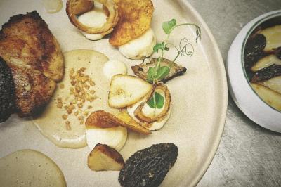 Noix de Saint-Jacques poêlées avec purée de légumes, chips croustillante et garniture de jambon et herbes fraîches.