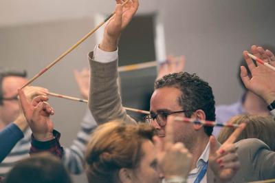 Un groupe de personnes souriantes rassemblées dans une ambiance conviviale lors d'un événement en intérieur.