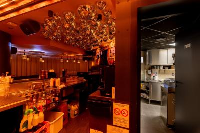 Plan d’aménagement intérieur montrant la disposition d’une cuisine, d’un bar, d’une salle principale et d’un espace lounge.