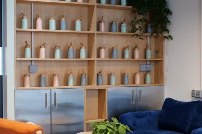 Façade d'un restaurant avec une vitrine éclairée, une porte centrale et des affiches de plats sur la droite.