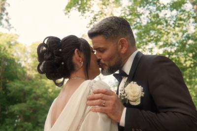 Femme en robe de mariée posant près d'albums photo élégants, entourée de bijoux et d'un décor raffiné.