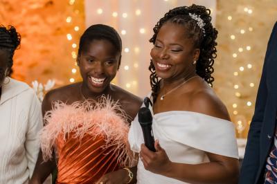 Femme en robe de mariée posant près d'albums photo élégants, entourée de bijoux et d'un décor raffiné.