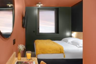 Douche avec carrelage blanc, robinetterie chromée, lavabo avec vase de fleurs séchées et flacon de savon.