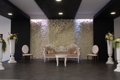 Salle de réception décorée avec des lumières rouges, tables dressées et projection lumineuse au sol.