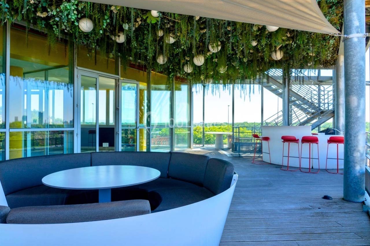 Location salle Caluire-et-Cuire (Rhône) - Le Belvédère #9 Espace extérieur avec mobilier moderne, plafond végétalisé et vue dégagée, aménagé sur une terrasse en bois.