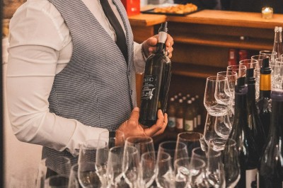Tentacules de poulpe en train de cuire dans une poêle, manipulés avec une pince en métal.