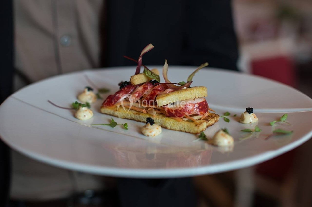 Assiette gastronomique avec une présentation soignée de toasts, charcuterie, mousse et garnitures décoratives.