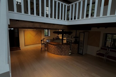 Vue d'un intérieur avec un espace ouvert, un bar en briques, un parquet clair et une mezzanine avec rambarde blanche.