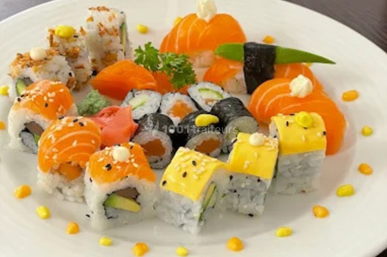 Assortiment de sushis et makis variés avec garnitures colorées, présenté sur une assiette blanche.