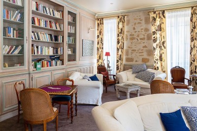 Salle de bain moderne avec douche à l'italienne, lavabo sur plan en bois, miroir éclairé et porte-serviettes mural.