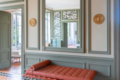 Un couple en tenue de mariage se tient devant une grande table décorée, avec un manoir en arrière-plan.