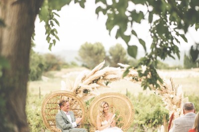 Assiette avec un morceau de viande nappé de sauce, purée, garniture de légumes et fleur comestible en décoration.