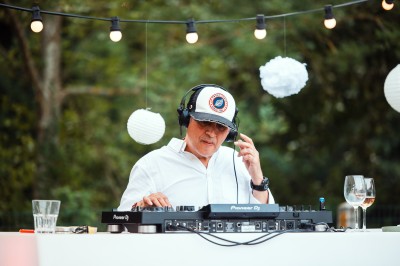 Salle de conférence avec des rangées de chaises colorées face à un écran de projection allumé.