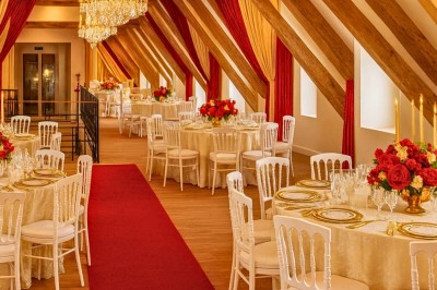 Miniature Location salle Magny (Yonne) - Château de Marrault #33 Salle de réception élégante avec tables décorées, nappes blanches, chandeliers dorés, fleurs rouges et tapis rouge.
