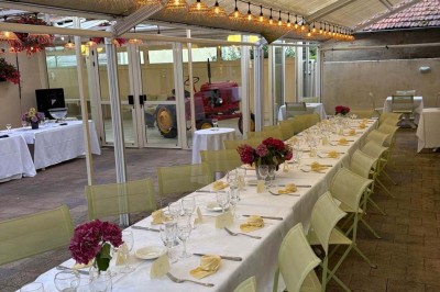 Miniature Location salle Condeissiat (Ain) - Restaurant Rolande #9 Une voiture Citroën 2CV rouge et blanche est garée devant un restaurant à façade fleurie dans un village.