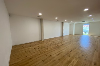 Décoration lumineuse avec le chiffre 18 éclairé et des ballons dorés et blancs dans une pièce sombre.