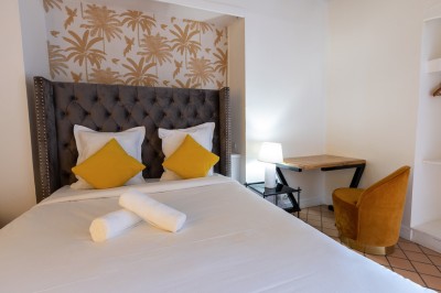 Assiette de crevettes grillées servies avec légumes et herbes fraîches, accompagnée de plats en arrière-plan.