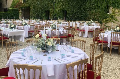 Assiette de crevettes grillées servies avec légumes et herbes fraîches, accompagnée de plats en arrière-plan.