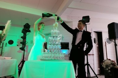 Personnes dansant dans une salle éclairée par des lumières colorées, ambiance festive en soirée.