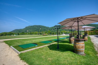 Bain à remous en fonctionnement avec eau bouillonnante, entouré d'un mur en pierre et d'un mur rouge.
