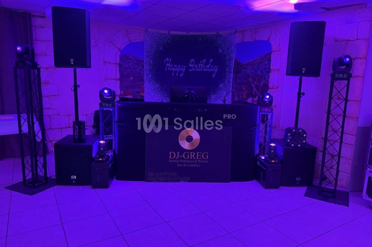 Installation de matériel de sonorisation et d'éclairage dans une salle décorée pour une fête d'anniversaire.