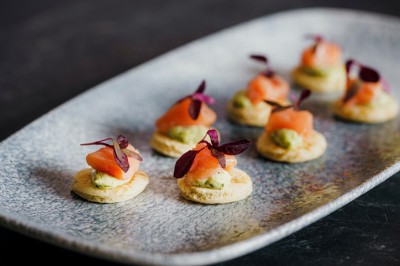 Desserts variés présentés dans des verrines, incluant des mousses, fruits frais et pâtisseries en arrière-plan.