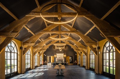 Salle de bain moderne avec lavabo sur plan en bois, miroir éclairé et douche à paroi en marbre noir.