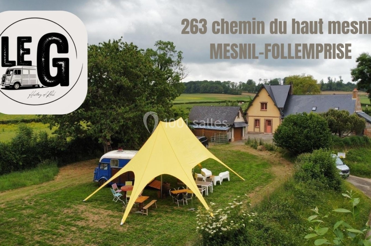 Vue aérienne d'un espace extérieur avec une tente jaune, des tables, un van et une maison en arrière-plan.