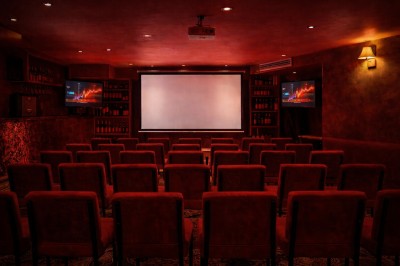 Miniature Location salle Paris 2 (Paris) - Culot #2 Salle intimiste éclairée de lumières rouges, avec canapés, petites tables rondes et rideaux sombres en arrière-plan.