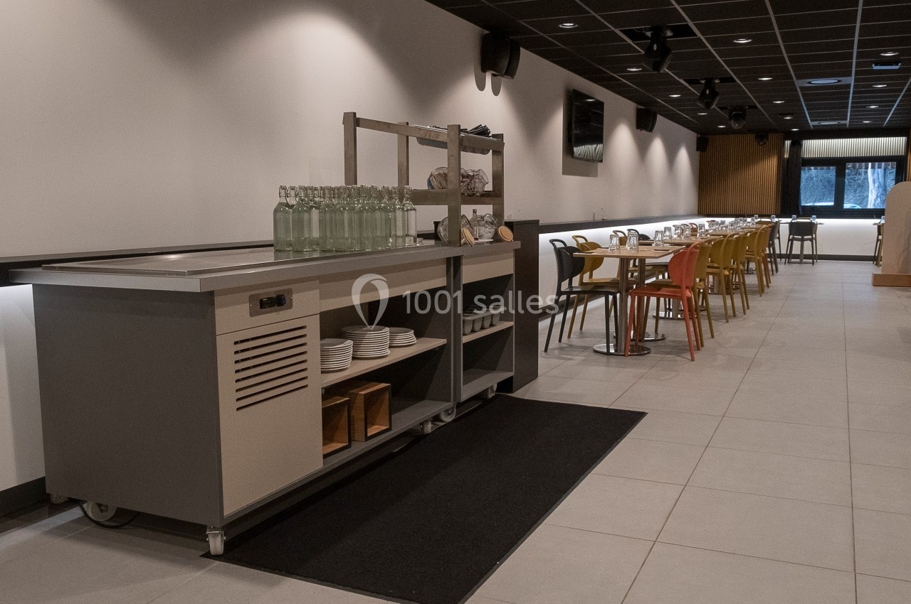 Location salle Marines (Val-d'Oise) - Stand Ing Events #16 Salle de restaurant moderne avec tables alignées, chaises colorées et un buffet équipé de rangements au premier plan.