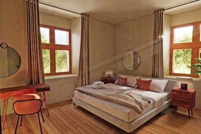 Vue aérienne d'un château en briques rouges entouré de pelouses bien entretenues et d'arbres.