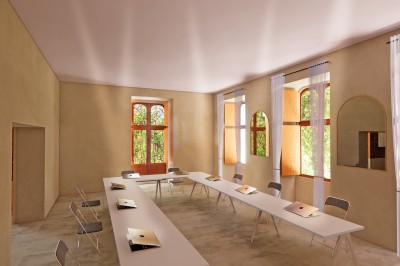 Vue aérienne d'un château en briques rouges entouré de pelouses bien entretenues et d'arbres.