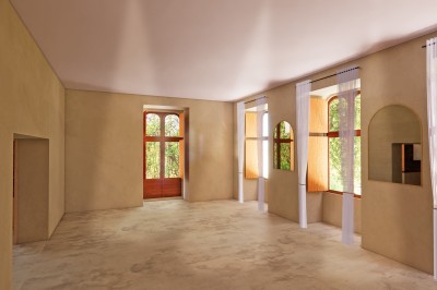 Vue aérienne d'un château en briques rouges entouré d'une pelouse bien entretenue et d'arbres.