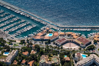 Une chanteuse en robe dorée se produit sur scène, entourée d'un chœur en tenues assorties, sous un éclairage bleu.