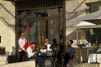 Assiette blanche contenant une présentation soignée de fraises, feuilles et sauce rouge sur un motif doré.