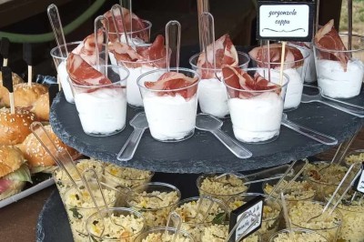 Plateaux garnis de charcuteries variées, cornichons et tranches de salami, présentés en trois tailles différentes.